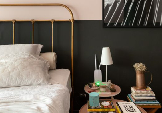 quarto com parede bicolor preto e rosa com cama com cabeceira de metal