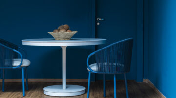 Imagem de ambiente azul com cadeiras de ferro pintadas